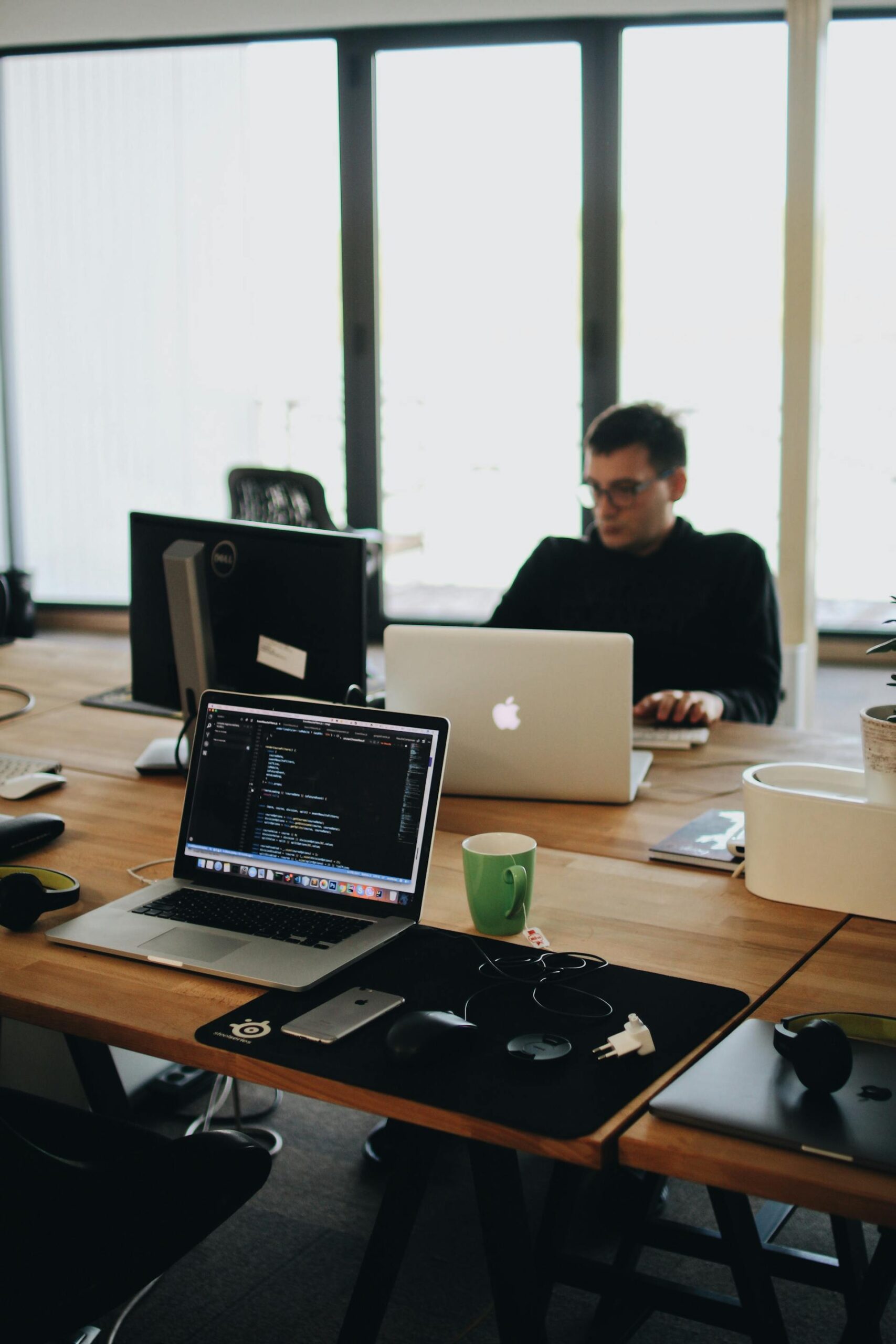 a man sitting in front of laptops